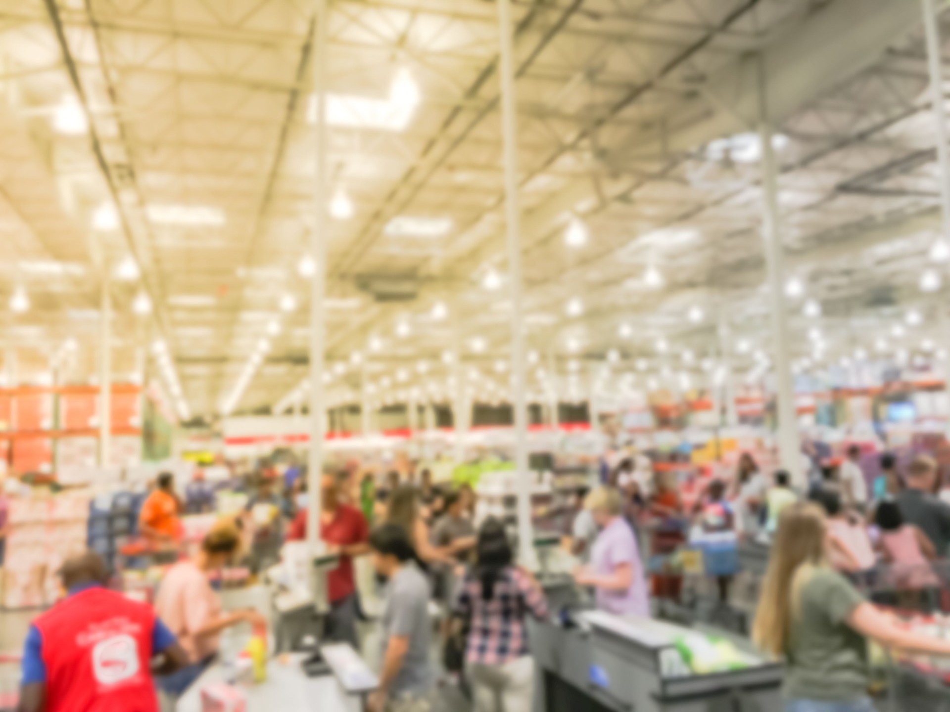 Blurred busy checkout counter with clerk support at wholesale store